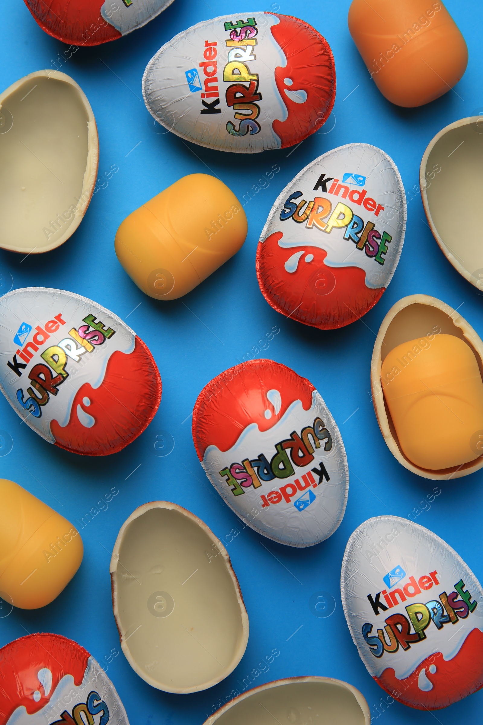 Photo of Sveti Vlas, Bulgaria - June 29, 2023: Kinder Surprise Eggs and plastic capsules on light blue background, flat lay