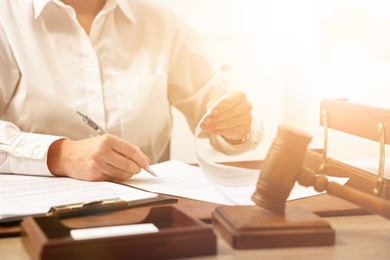 Image of Lawyer working with document at table in office, closeup