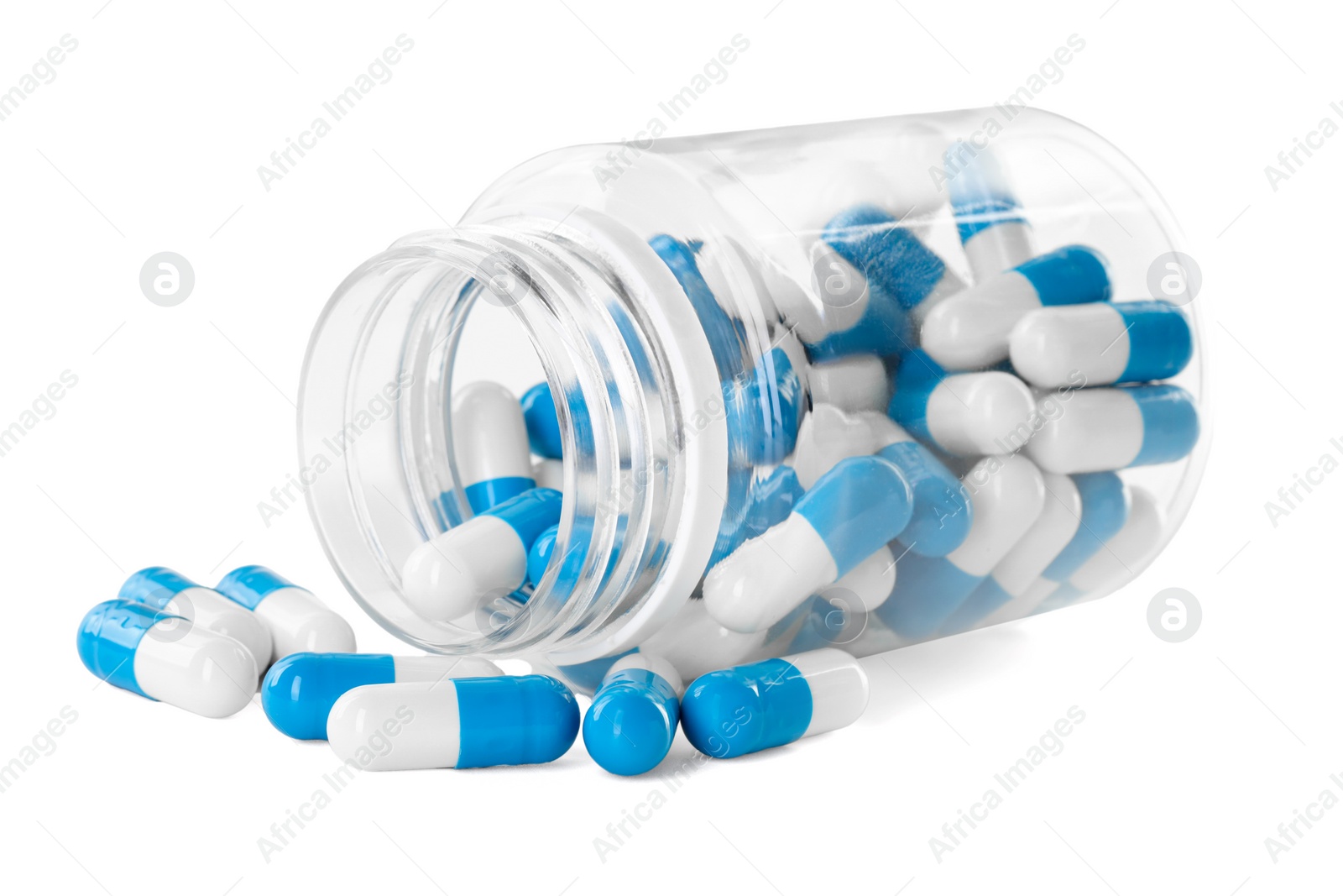 Photo of Scattered antibiotic pills and bottle isolated on white