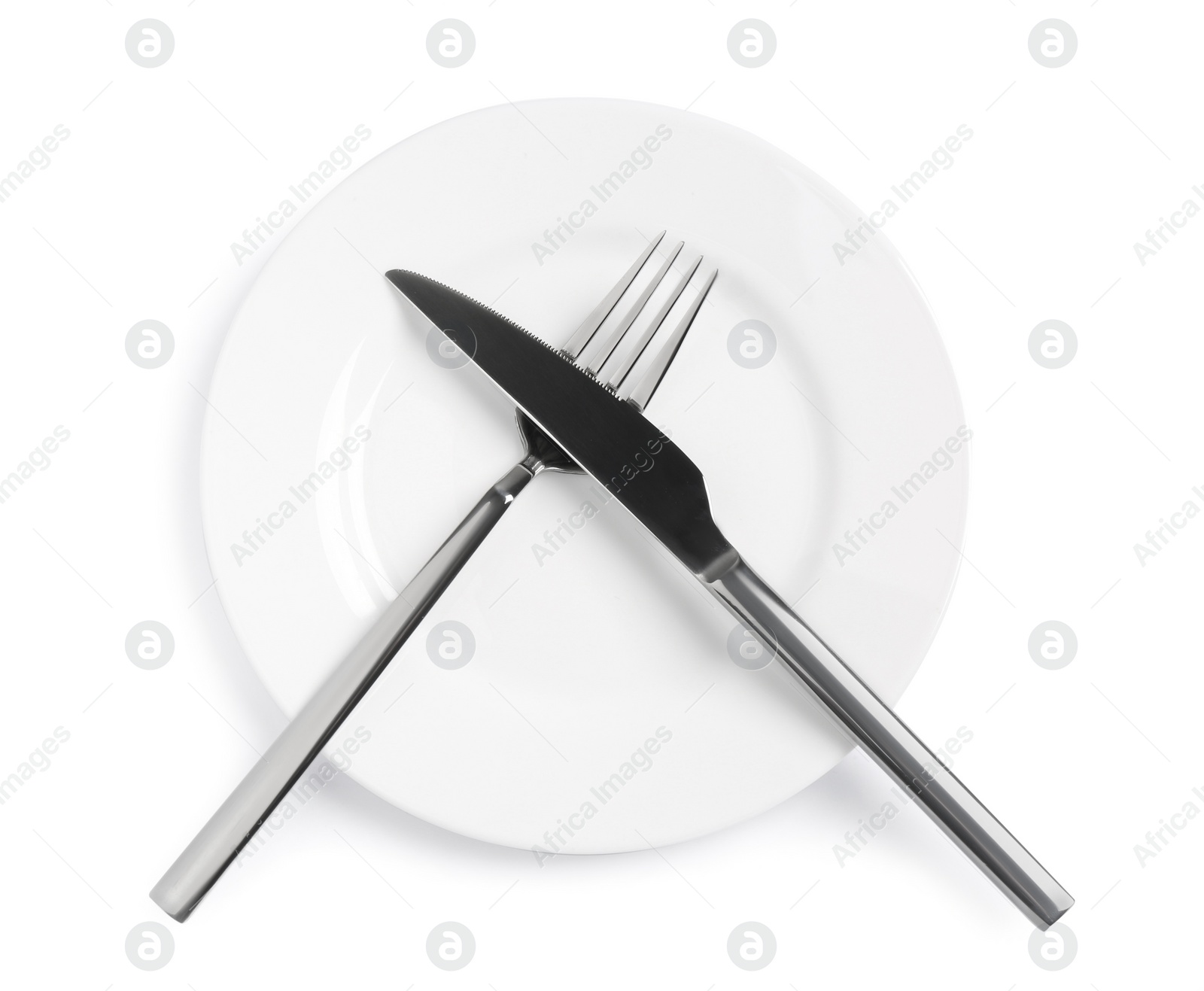 Photo of Clean plate with shiny cutlery on white background, top view