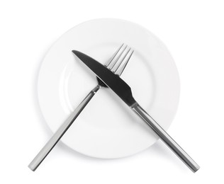 Photo of Clean plate with shiny cutlery on white background, top view