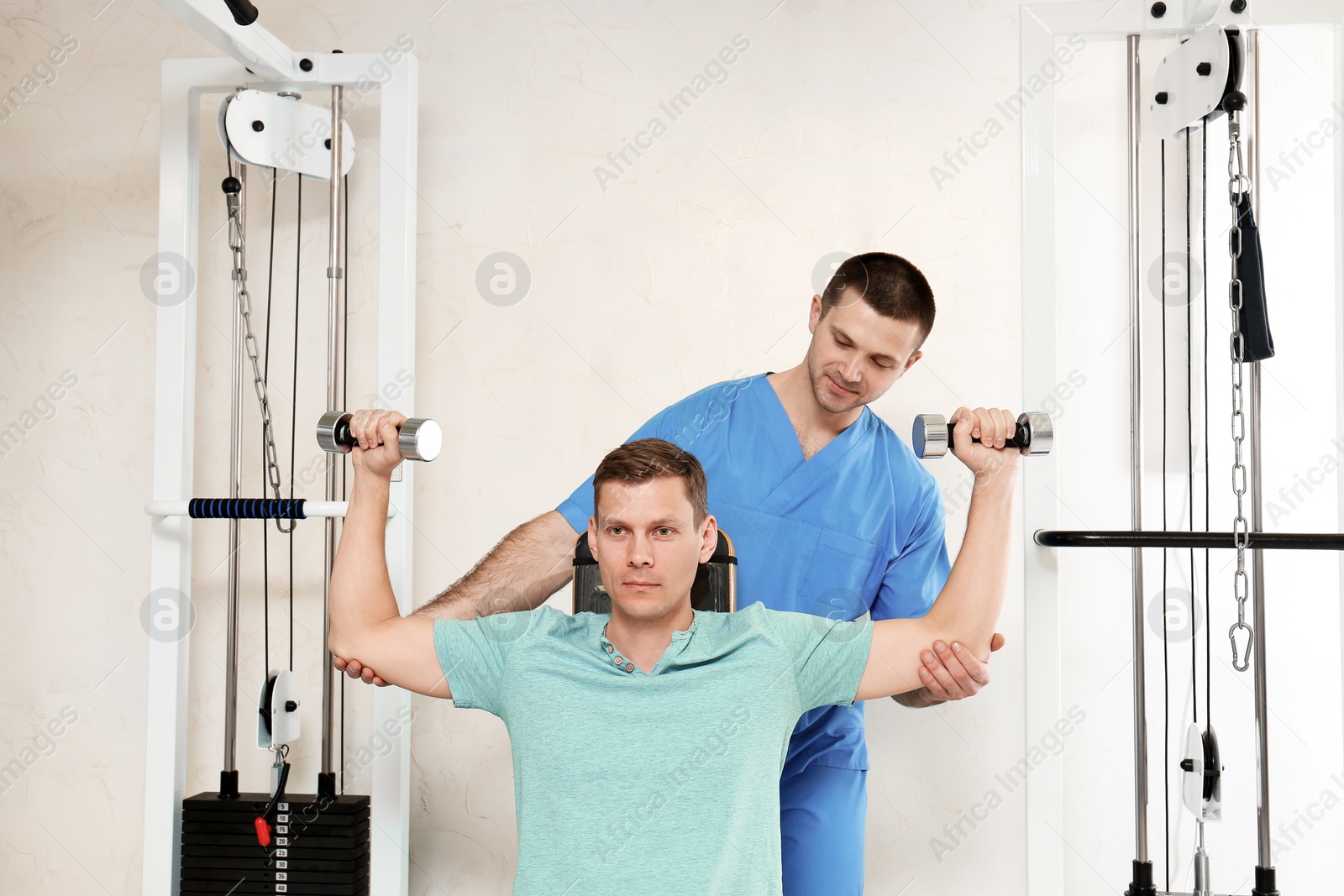 Photo of Patient exercising under physiotherapist supervision in rehabilitation center