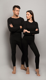 Photo of Couple wearing thermal underwear on grey background