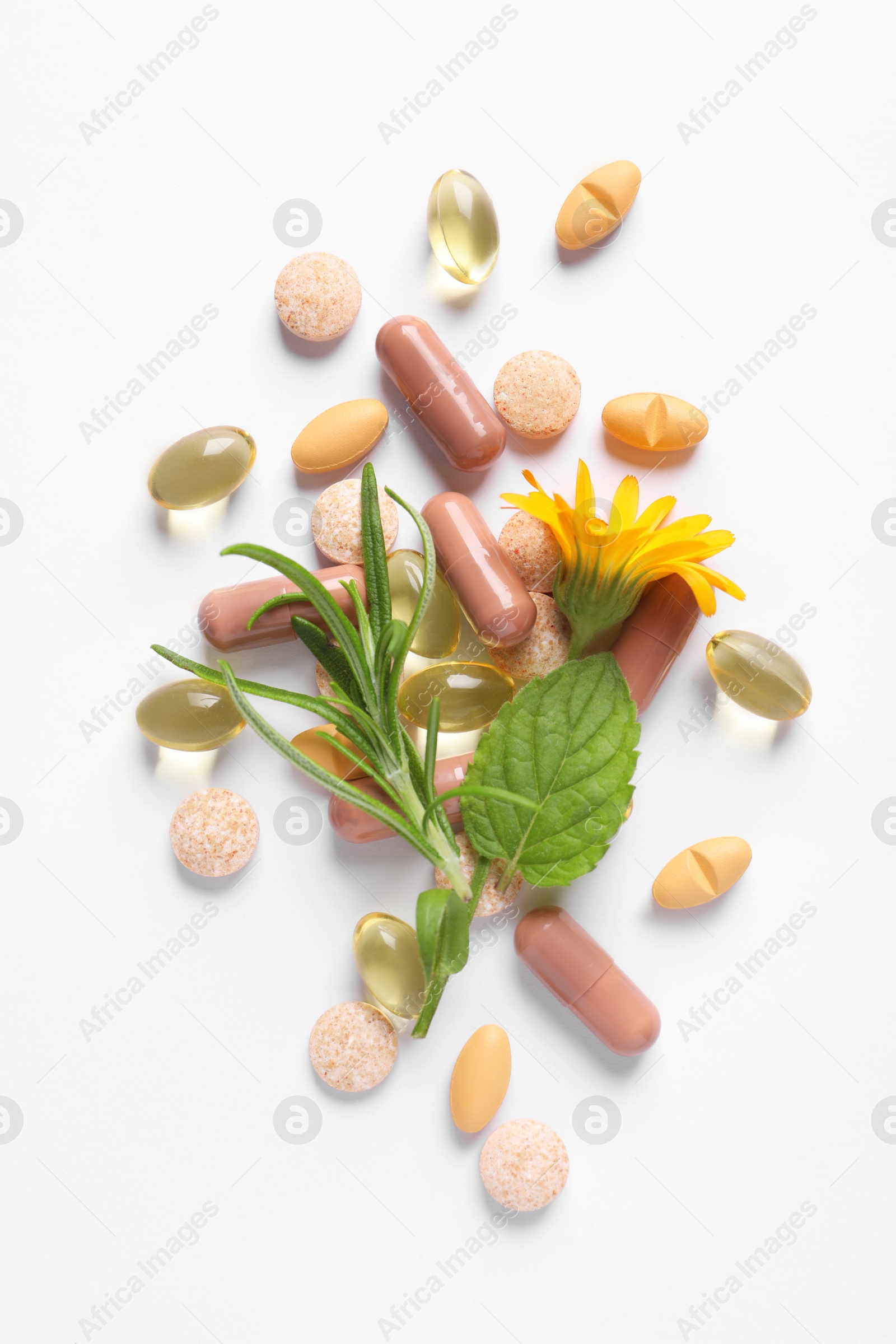 Photo of Different pills, herbs and flower on white background, flat lay. Dietary supplements