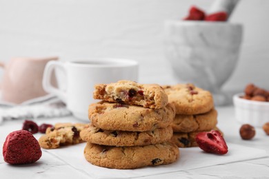 Photo of Cookies with freeze dried fruits and nuts on white marble table, closeup