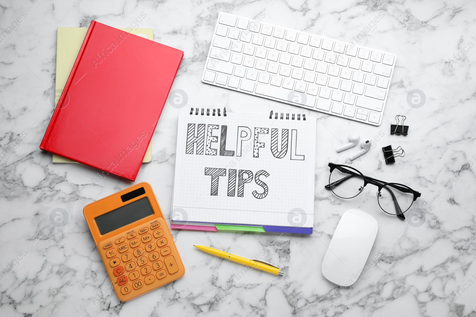 Photo of Flat lay composition with text Helpful Tips in notebook on white marble table