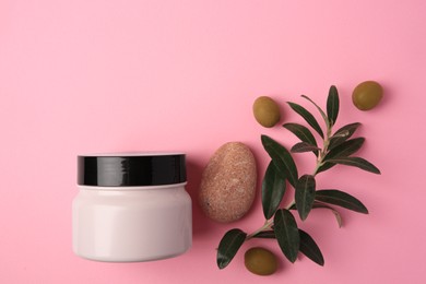 Natural cosmetic. Olive cream, pebble stone and ingredient on pink background, flat lay. Space for text