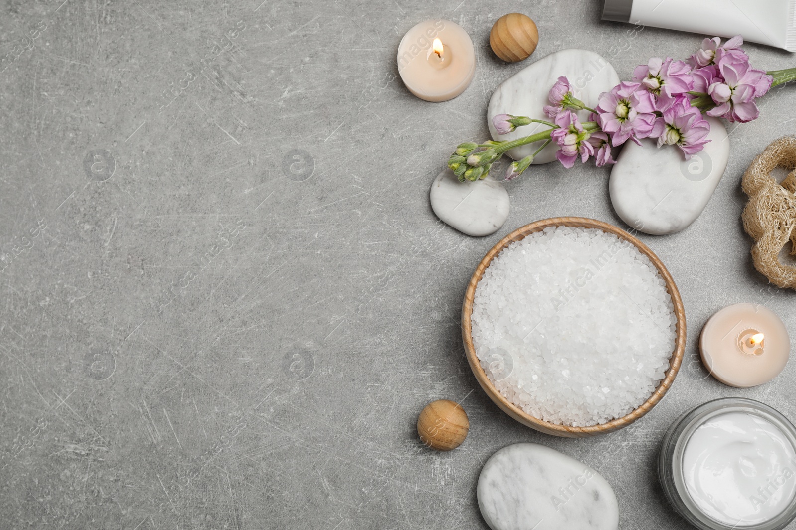 Photo of Flat lay composition with cosmetics on grey marble table, space for text. Spa treatment