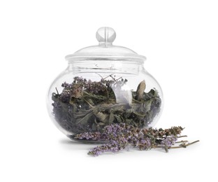 Photo of Glass jar with dry mint leaves and flowers isolated on white