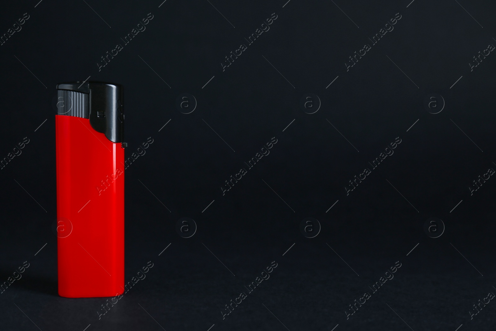 Photo of Stylish small pocket lighter on black background, space for text