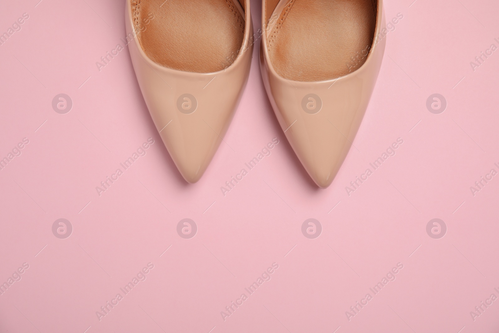 Photo of Pair of beautiful shoes and space for text on color background, top view