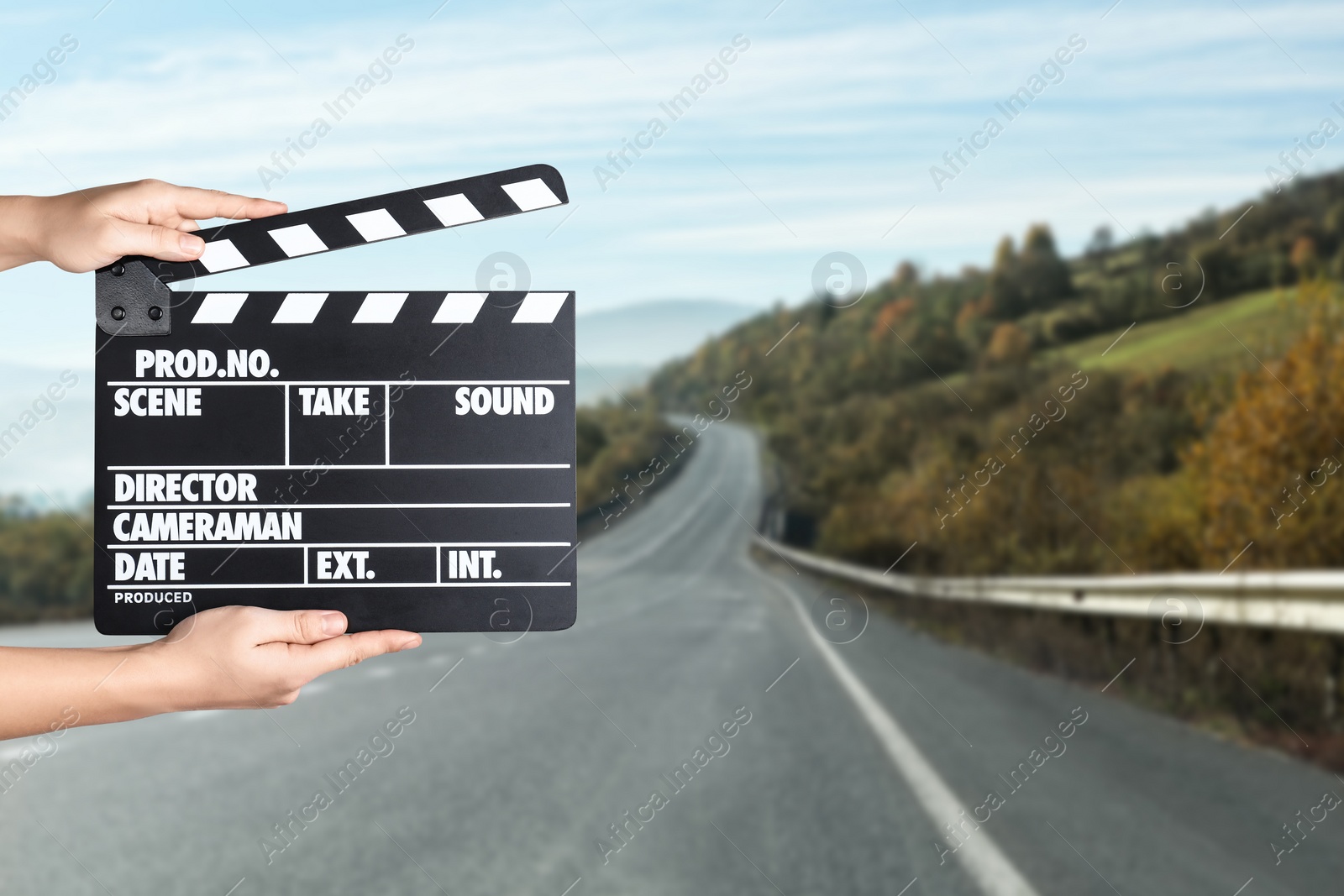 Image of Assistant holding clapperboard outdoors, closeup. Cinema production 