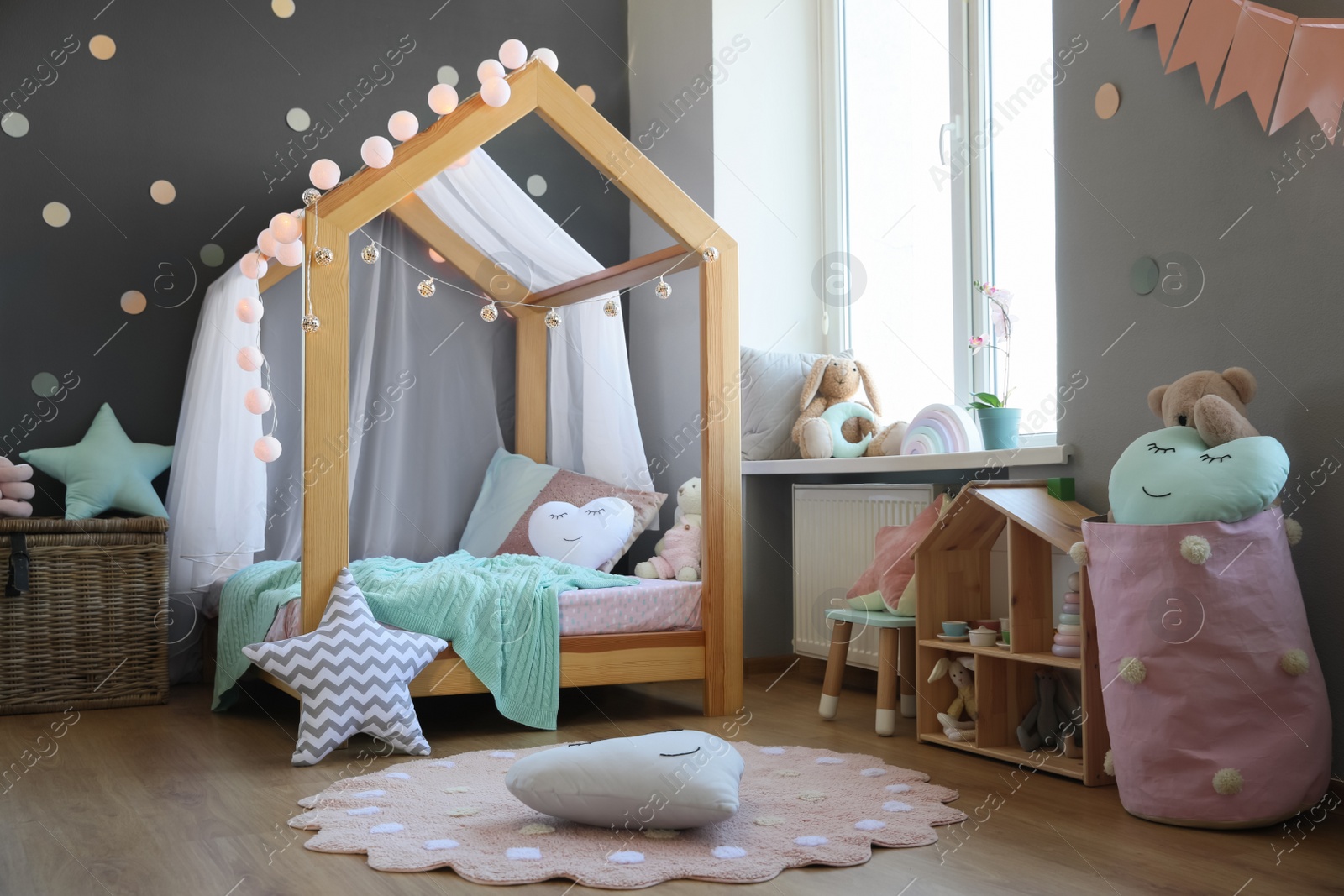 Photo of Stylish child room interior with house bed and different toys