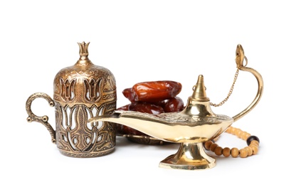 Photo of Aladdin magic lamp, dates and beads on white background