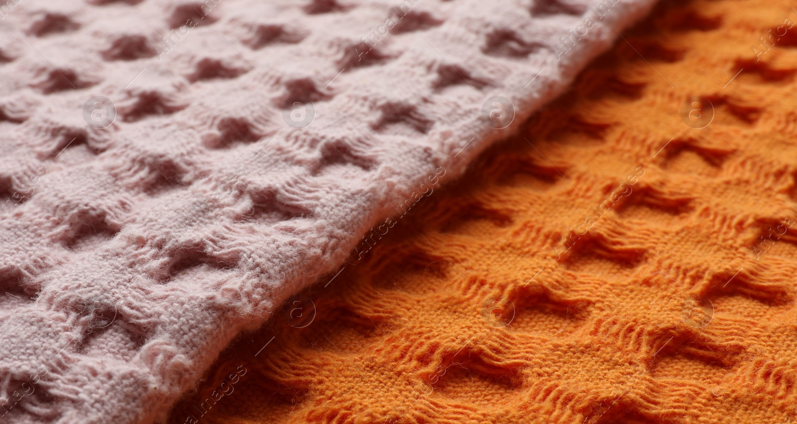 Photo of Orange and pink fabrics as background, closeup