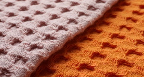 Orange and pink fabrics as background, closeup