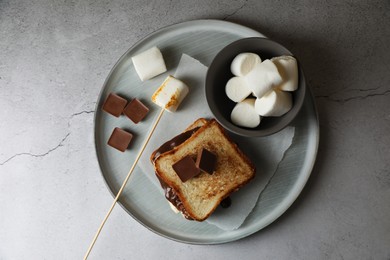 Photo of Delicious marshmallow sandwich and ingredients on light grey table, top view