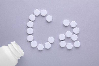 Photo of Open bottle and calcium symbol made of white pills on light grey background, flat lay