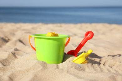 Bright child plastic toys on sandy beach