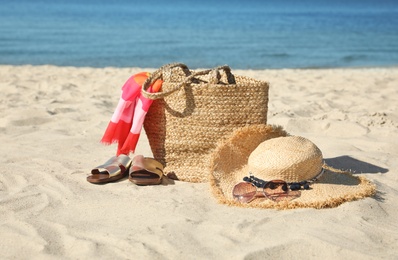 Stylish beach accessories on sandy sea shore