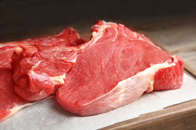 Photo of Fresh raw beef cut on table, closeup