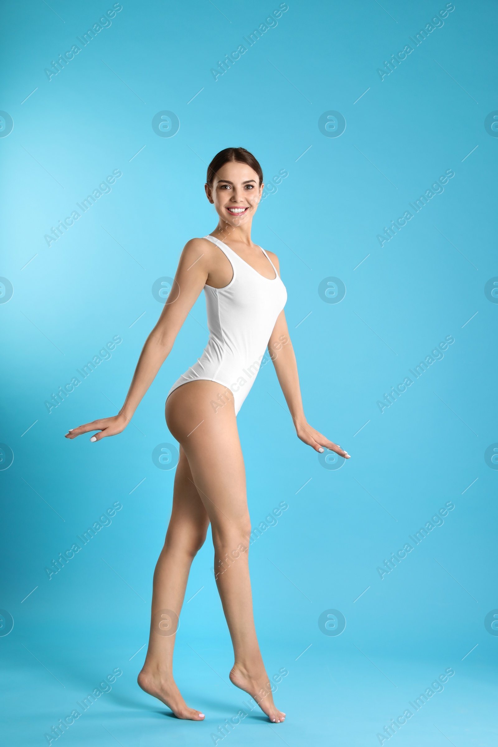 Photo of Full length portrait of attractive young woman with slim body in swimwear on color background