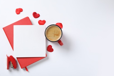 Photo of Flat lay composition with blank card on white background, space for text. Valentine's Day celebration