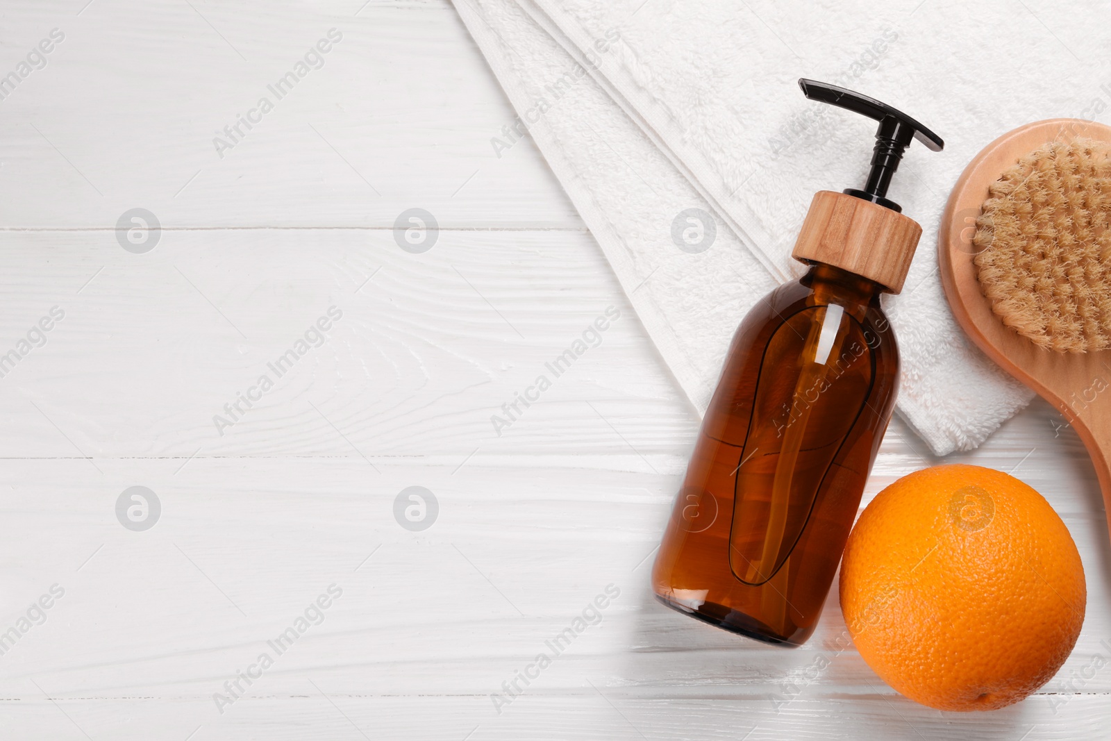 Photo of Cosmetic product, orange and brush on white wooden table, flat lay with space for text. Anti cellulite treatment