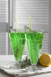 Photo of Glasses of homemade refreshing tarragon drink on table