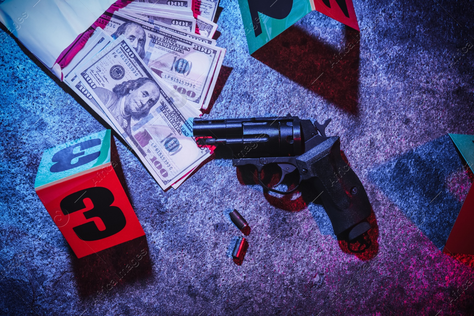 Photo of Evidences and crime scene marker on stone background, toned in red and blue. Flat lay