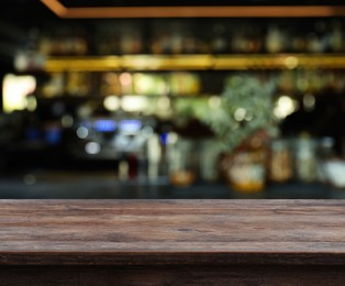 Image of Empty wooden surface and blurred view of bar interior. Space for design