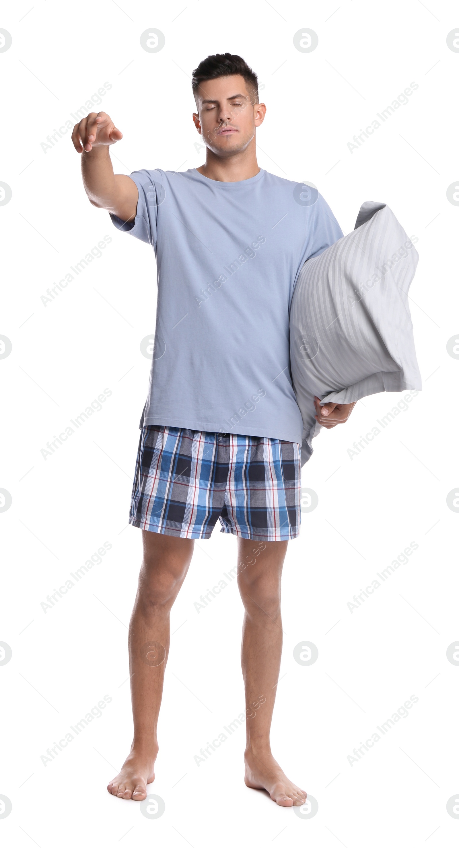 Photo of Somnambulist with soft pillow on white background. Sleepwalking