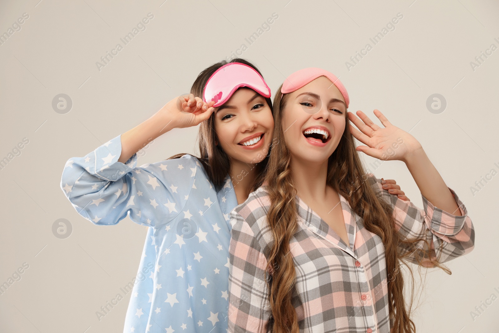 Photo of Beautiful women in pajamas on beige background. Bedtime