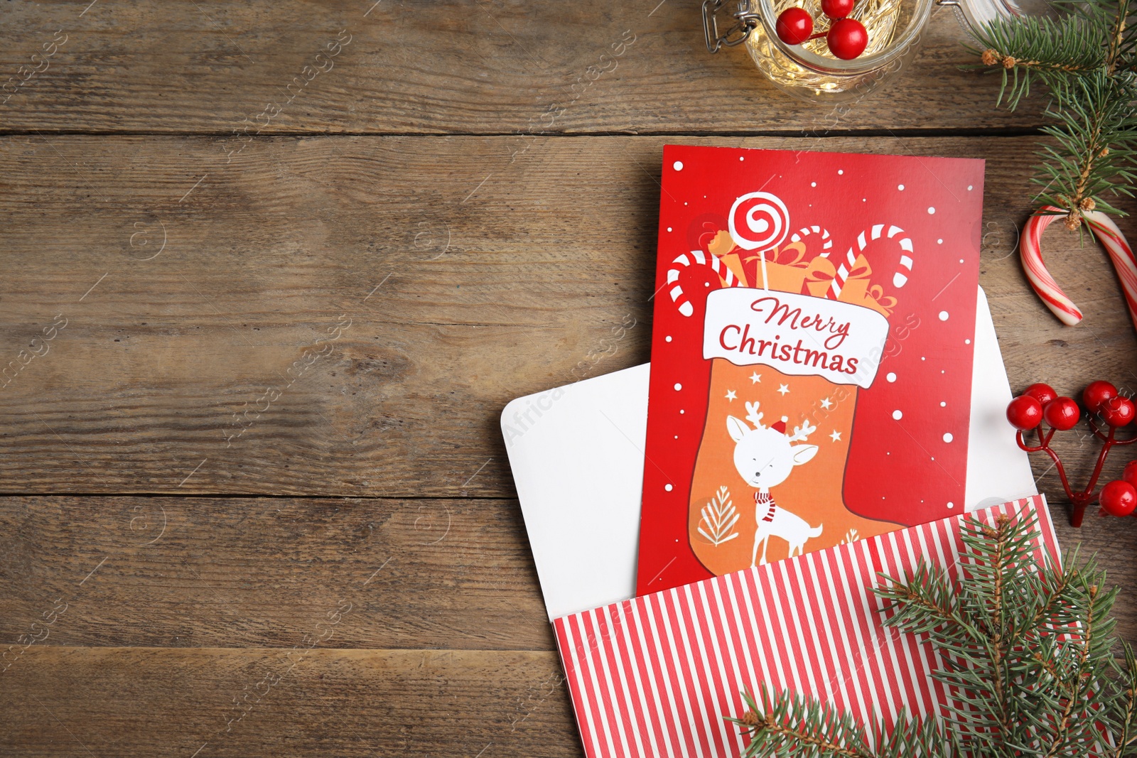 Photo of Flat lay composition with Christmas card on wooden background, space for text