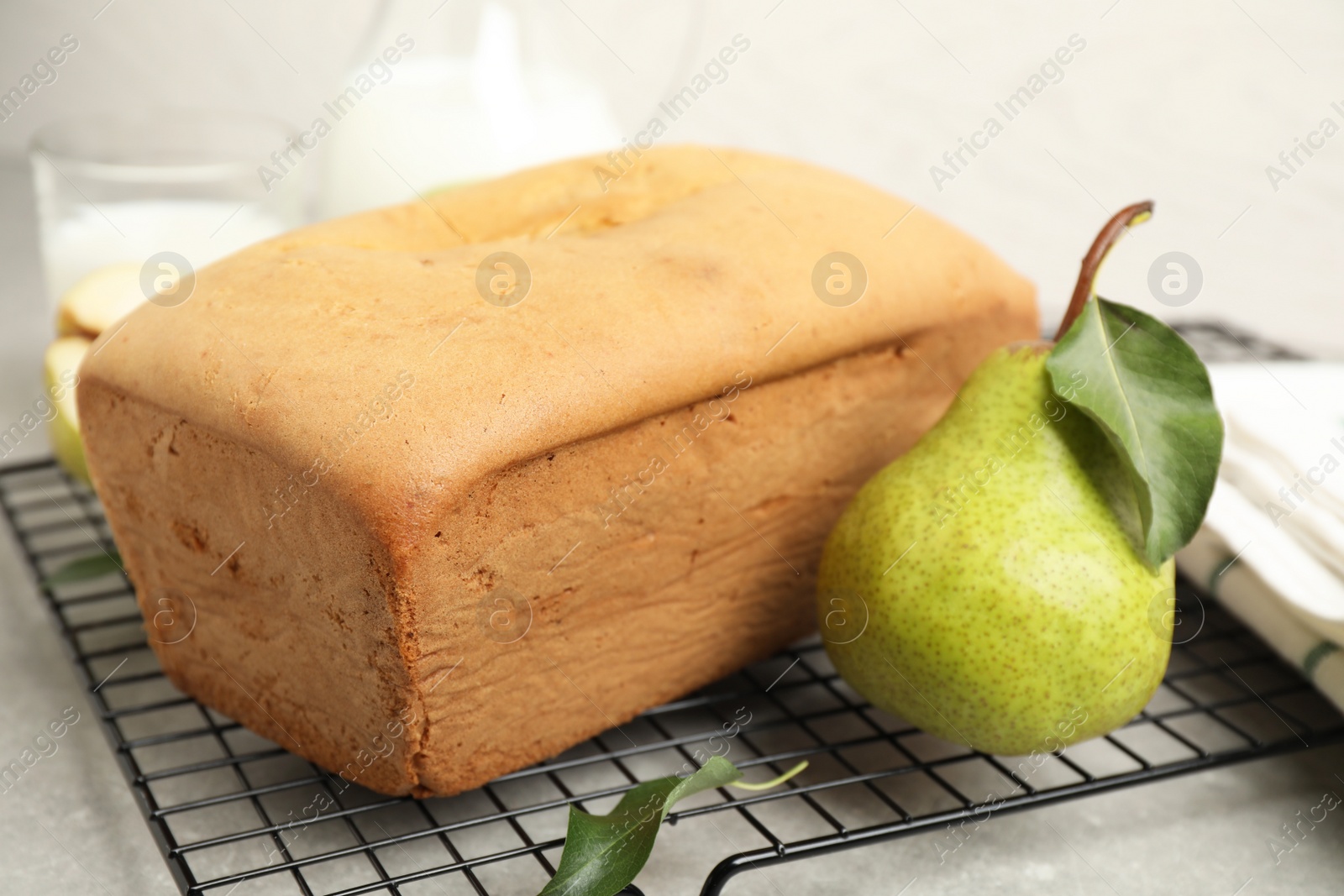 Photo of Tasty bread and pear on light grey table, closeup. Homemade cake