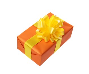 Photo of Orange gift box with yellow bow isolated on white