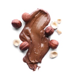 Photo of Delicious chocolate paste with hazelnuts on white background, top view