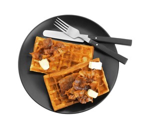 Photo of Plate with tasty Belgian waffles, bacon, butter and cutlery isolated on white, top view