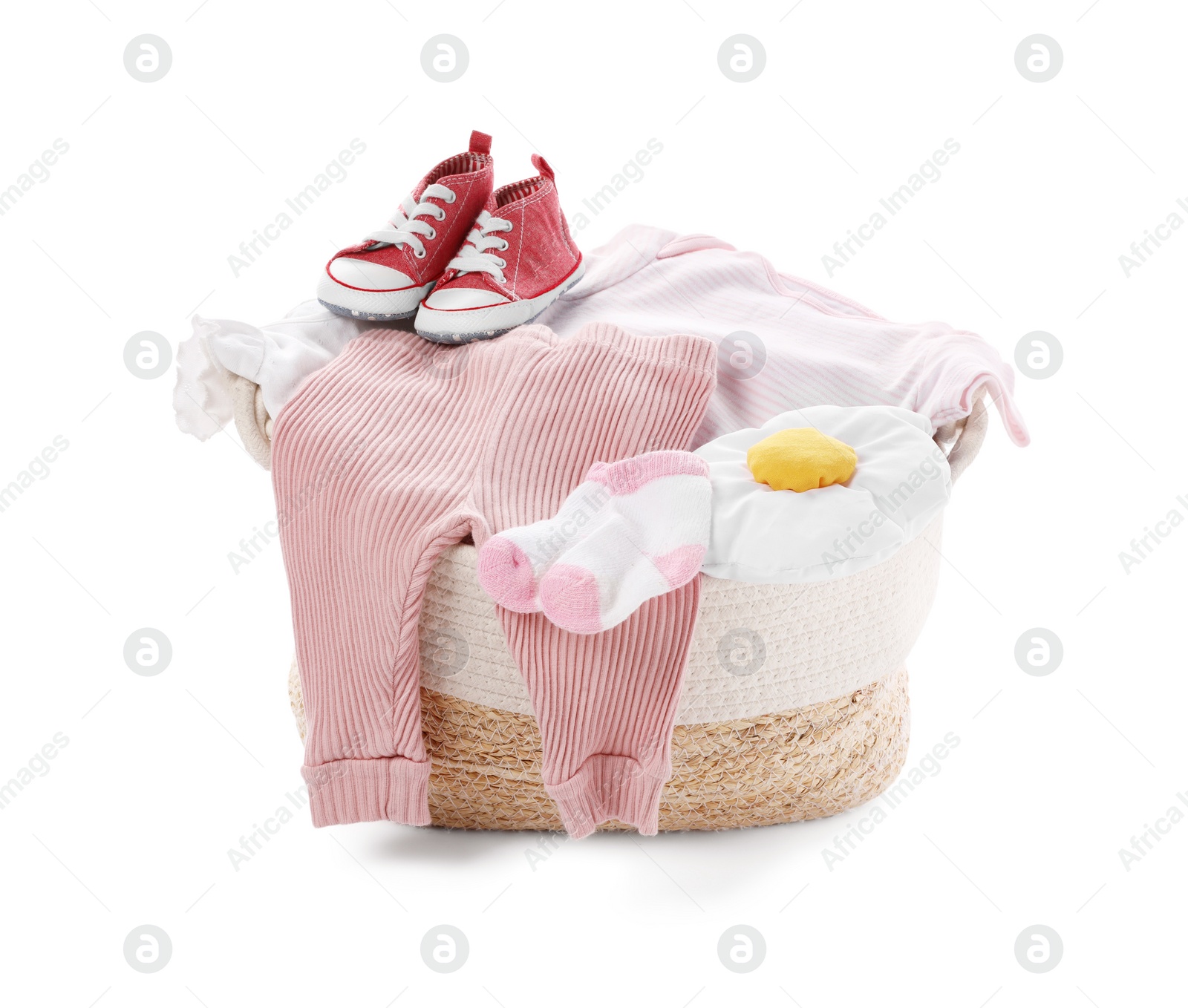 Photo of Laundry basket with baby clothes and shoes isolated on white