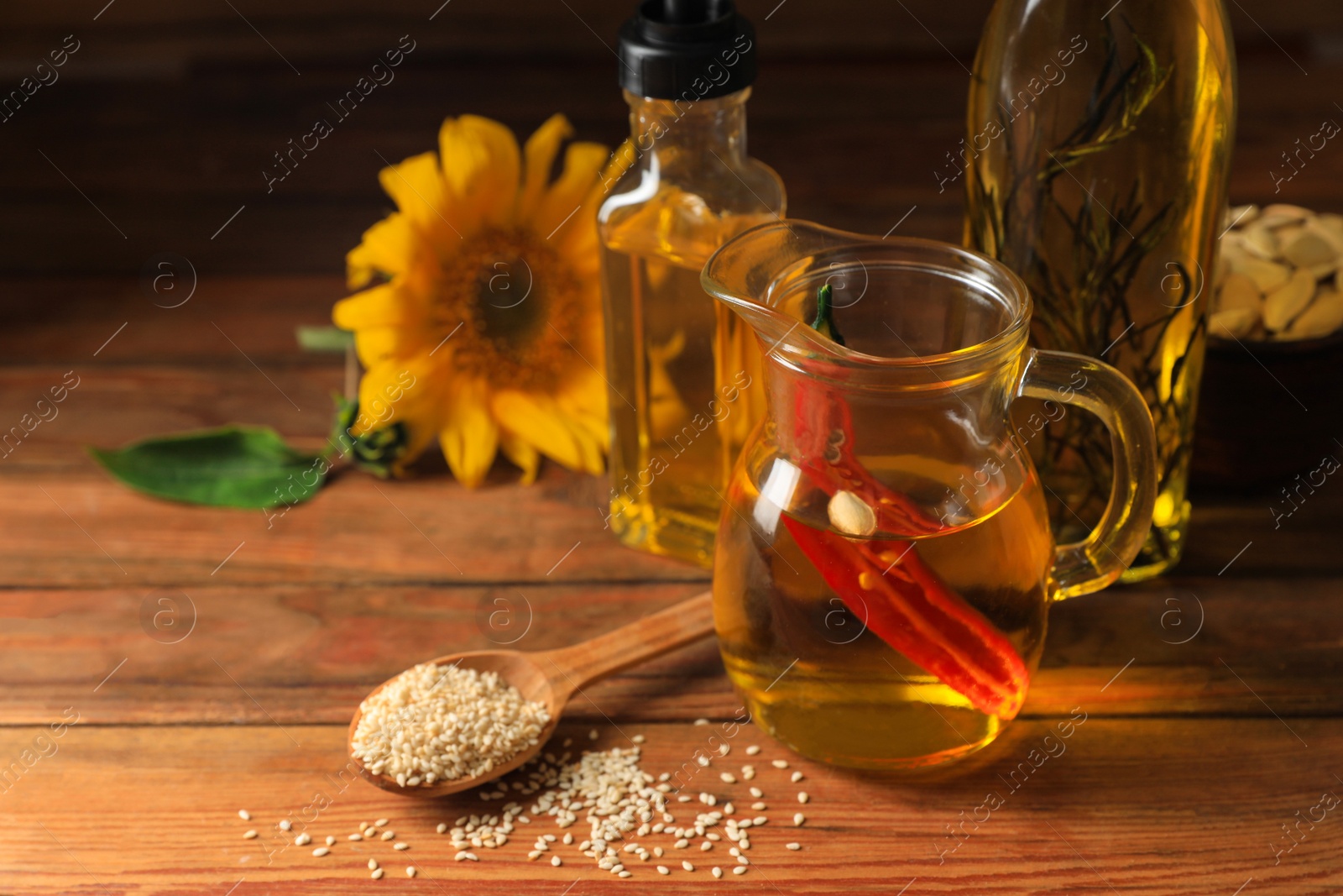 Photo of Different cooking oils and ingredients on wooden table