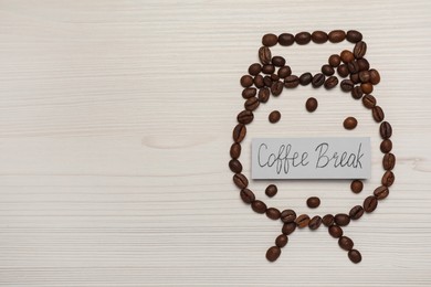 Photo of Alarm clock made of beans and card with phrase Coffee Break on white wooden table, flat lay. Space for text