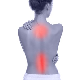 Woman suffering from back pain on white background
