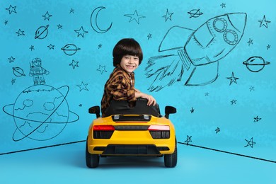 Cute little boy driving toy car and drawing of space on light blue background
