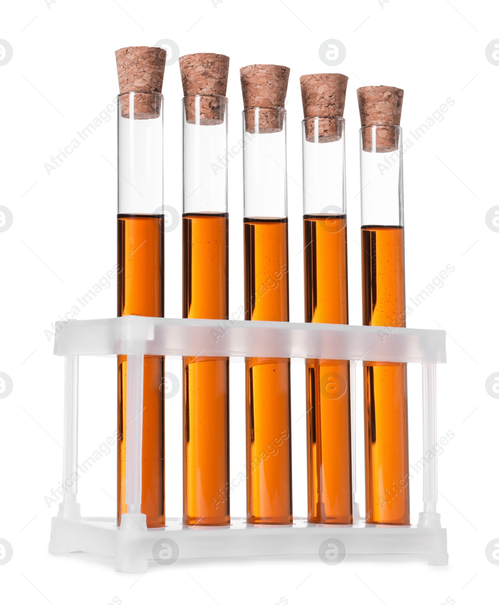 Photo of Test tubes with brown liquid in stand on white background