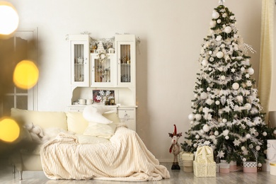 Stylish living room interior with decorated Christmas tree