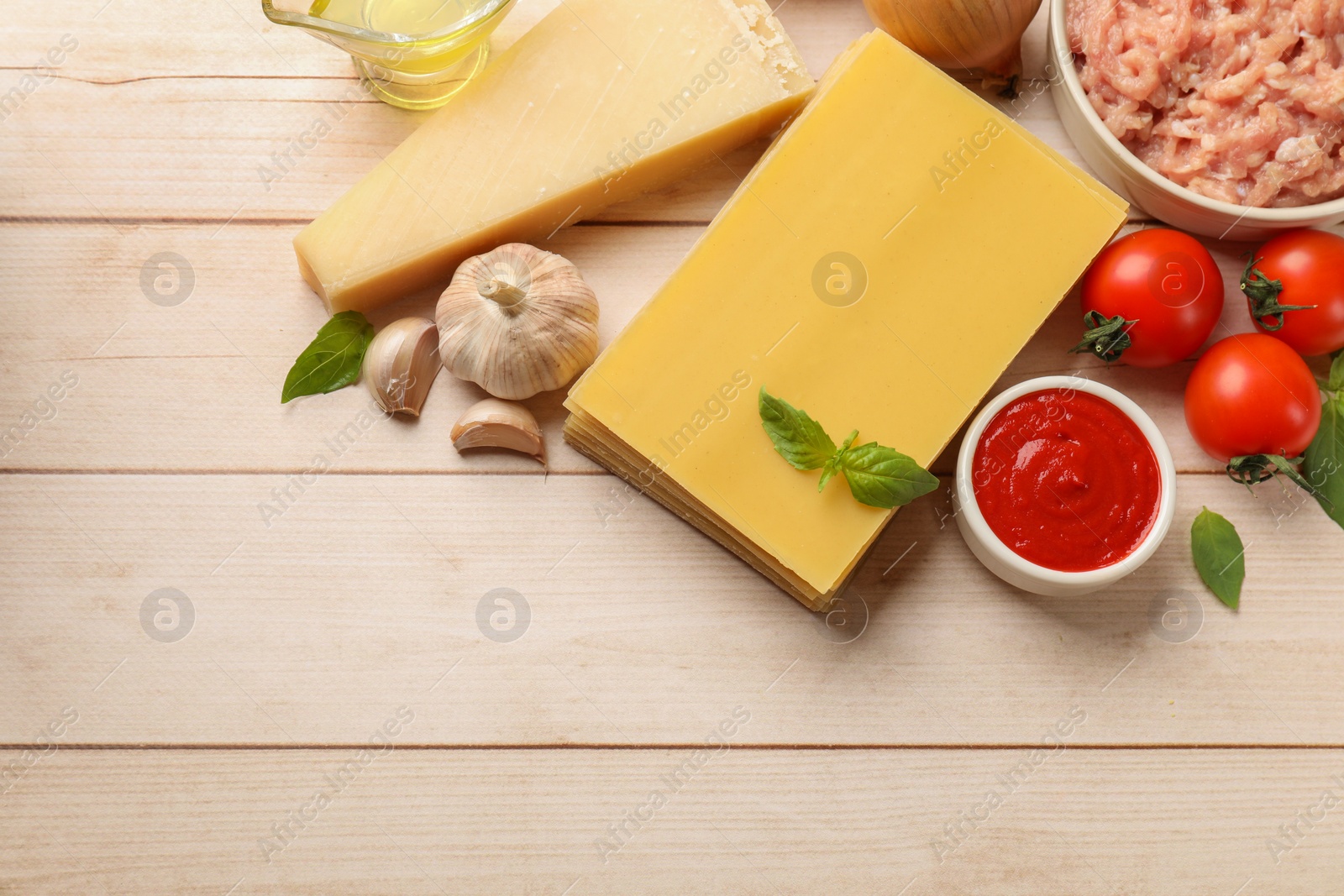 Photo of Ingredients for lasagna on white wooden table, flat lay. Space for text