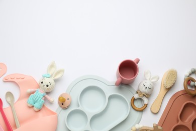 Photo of Composition with baby accessories and bib on white background, top view. Space for text