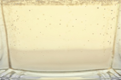 Closeup view of champagne with bubbles as background