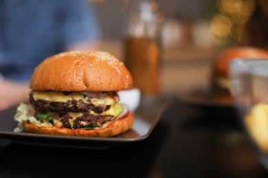 Tasty burger served on table in cafe. Space for text