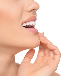 Photo of Young woman with beautiful smile on white background, closeup. Teeth whitening